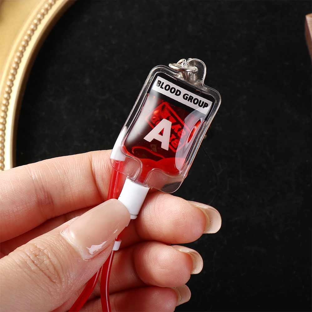 Phone Accessories Unique - ميدالية مفاتيح على شكل كيس دم
